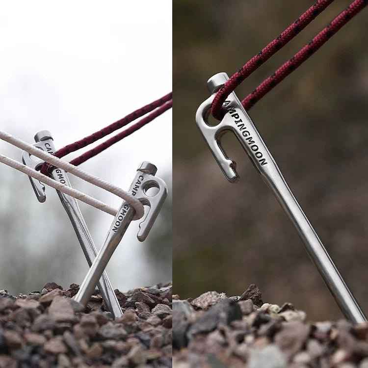 Nomadia Accessory Forged Camp Pegs attached to a rope on a natural background - tent pegs -camping essential