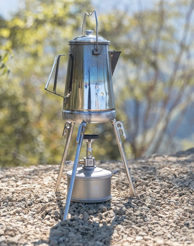 using Nomadia Accessory Forged Camp Pegs as a stove to stabilise a Stainless steel camping coffee percolator on a natural outdoor background - multi-use - multi-purpose - camping gear - camping eseential