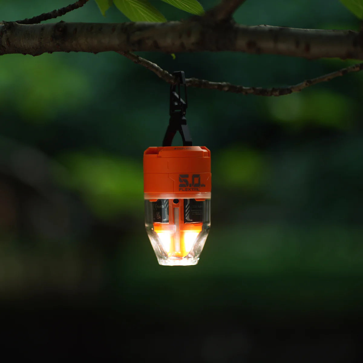 Nomadia Accessory High Speed 2-in-1 Rechargeable Air Pump works as a Portable camping light hanging from a branch with a blurred green background - multi-use - multi purpose