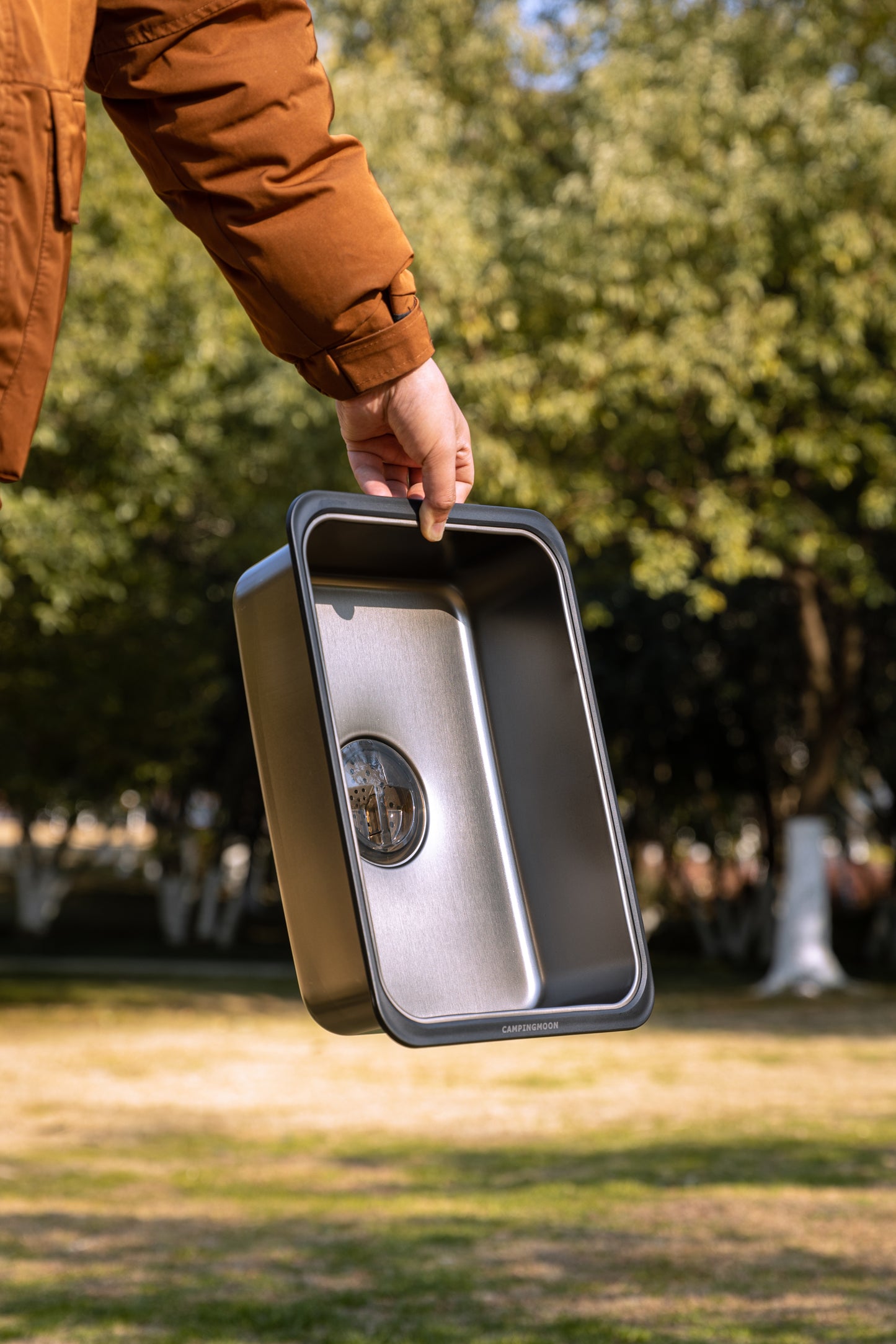 Person holding Nomadia CampStation Kitchen Sink outdoors - modular flexibility - modular fit - camping gear -outdoor cooking and washing equipment
