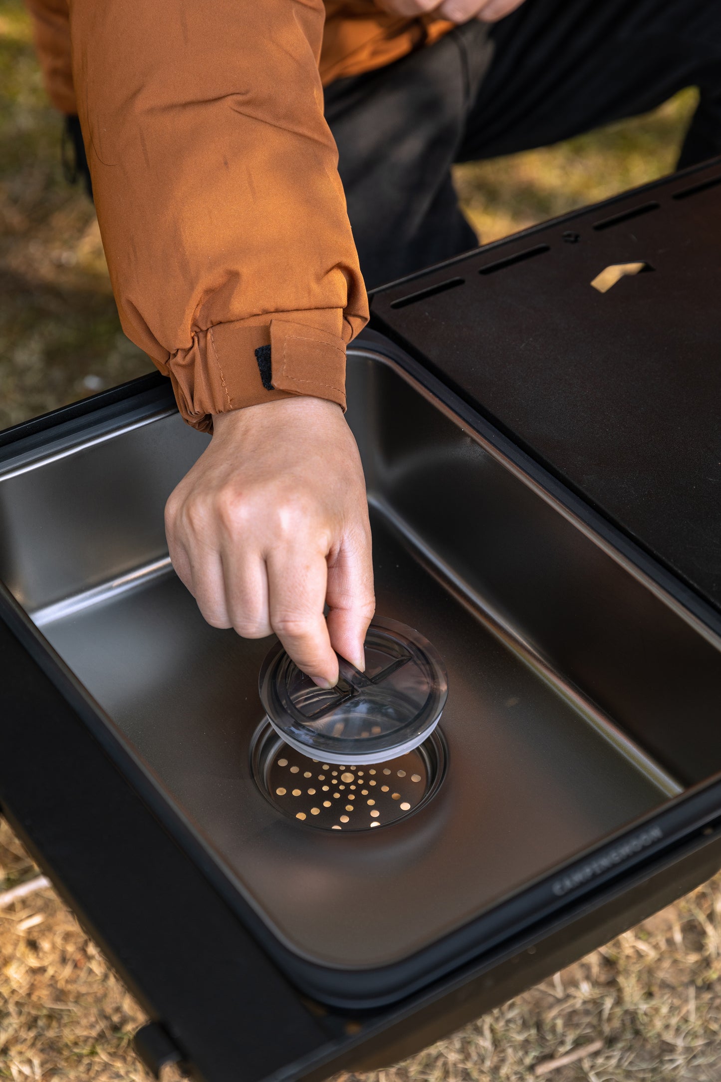Person using Nomadia CampStation Kitchen Sink outdoors, showing the large drainage and lid - camping gear - modular fit