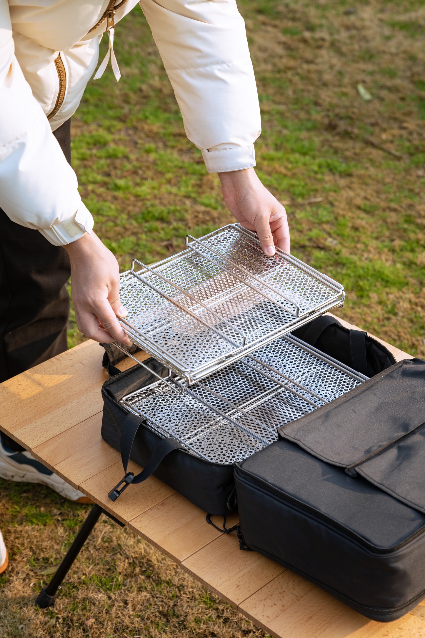 metal mesh basket folded ready to be put into the storage bag - camping gear - easy storage - glamping