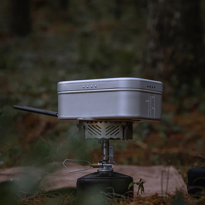 Nomadia CampStation Outdoor Aluminium Lunch Box over a stove in wildcamping setting - camping gear - outdoor cooking utensil