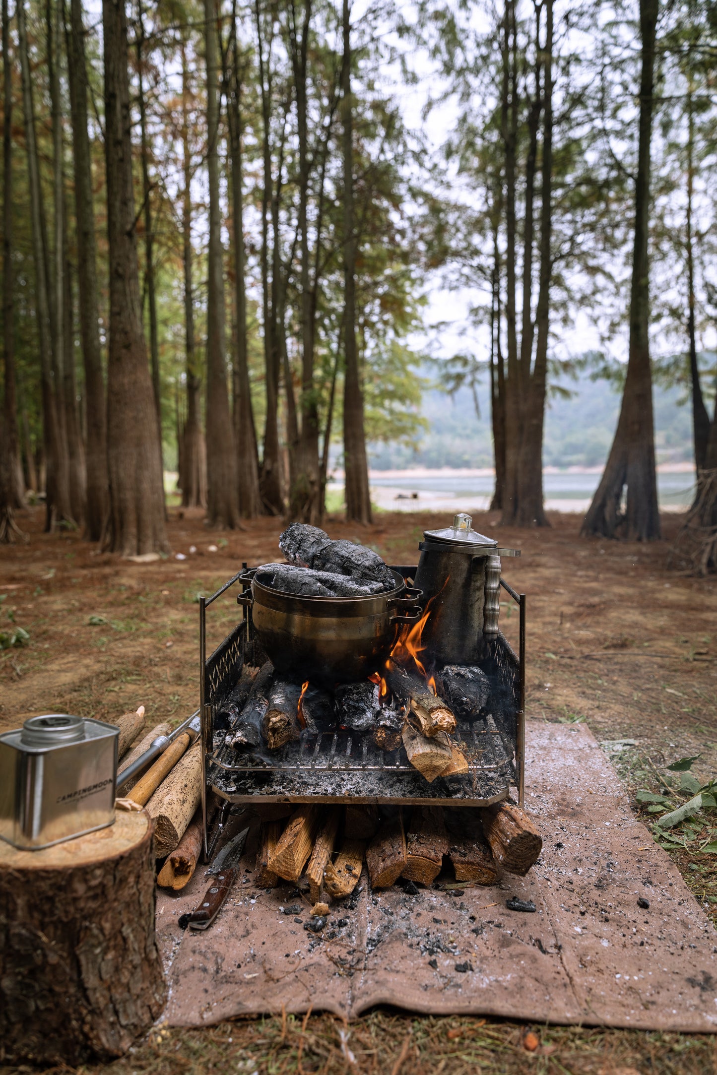 Campfire with Nomadia CampStation Stainless Steel Coffee Pot and wood in a forest setting - wild camping - outdoor cooking equipment - atmospheric camping