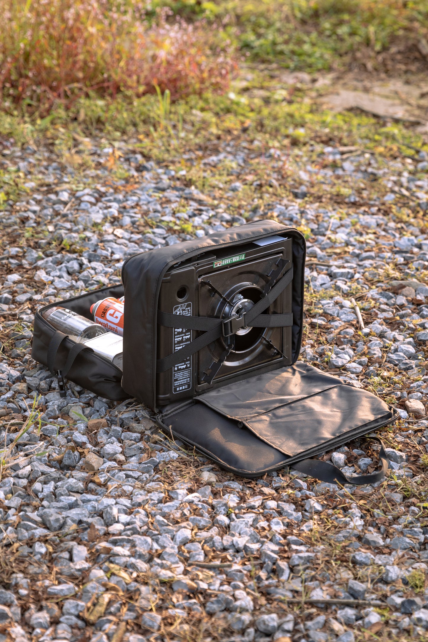 Black portable Nomadia CampStation Storage Bag on a gravel surface - uk camping - large storage compact camper bag