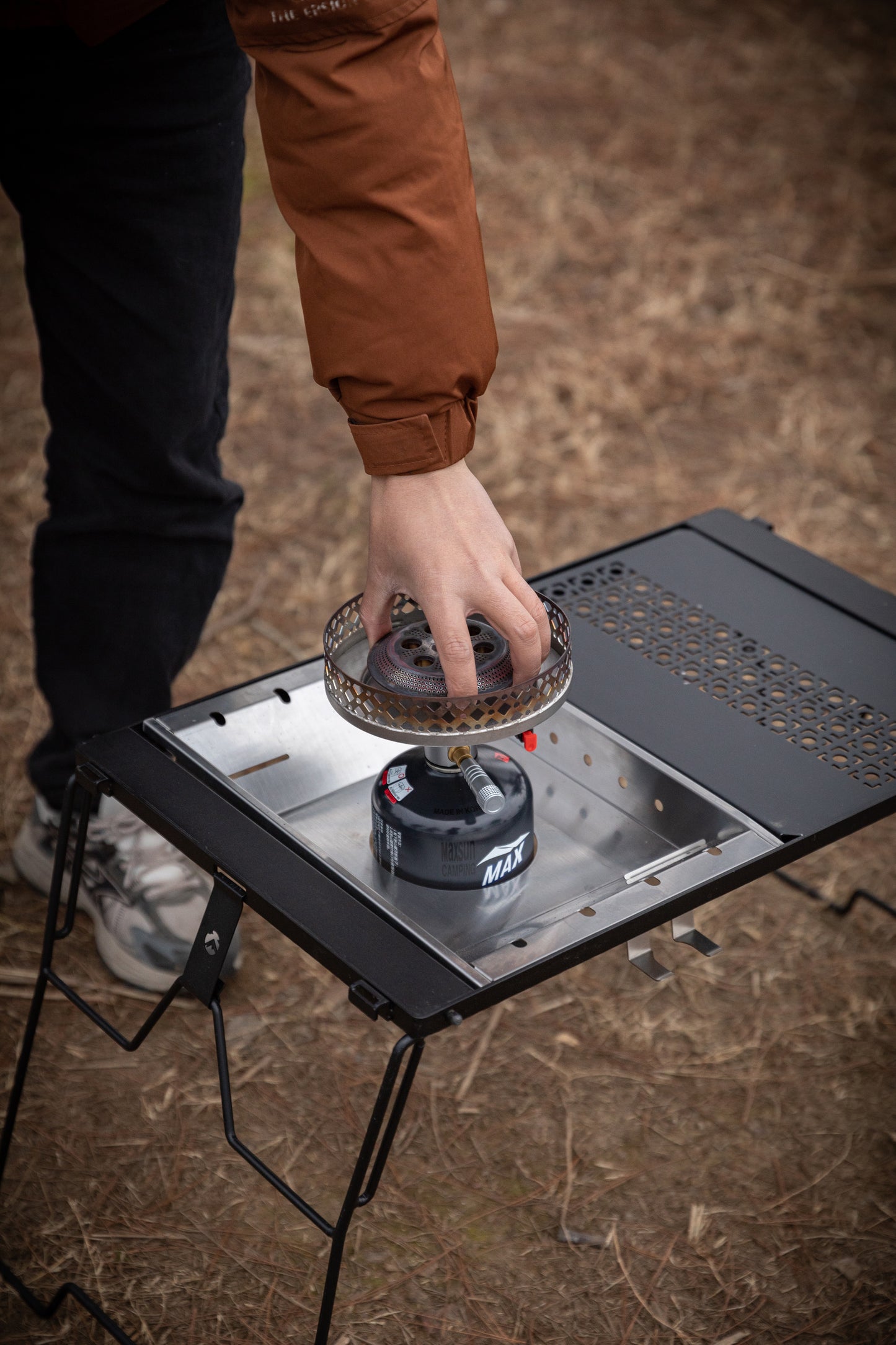 Person using a camping stove on a portable stove top Nomadia CampStation Stove Set - uk camping