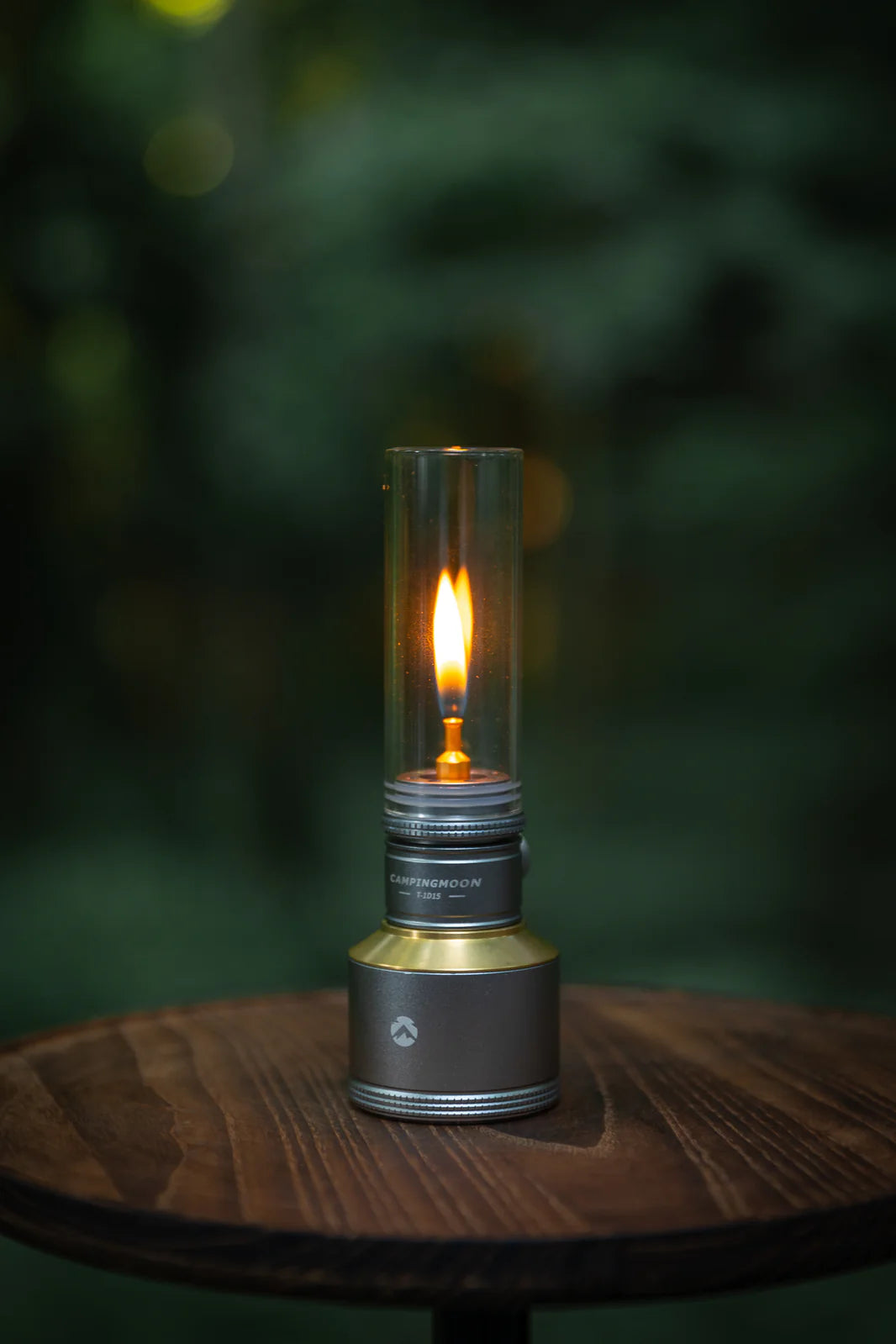 Flickering Nomadia Camping Light Candle-Style Gas Camping Lamp Set on a wooden surface - camping with a fire - uk camping - atmospheric light