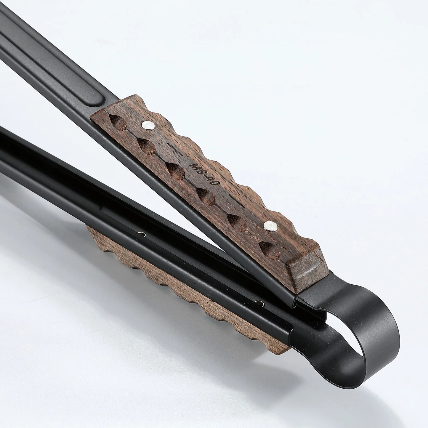 close up of the wood detail on Nomadia Flamo Wood Handle Outdoor Tongs - camping essential - camping gear -bbq grill accessory