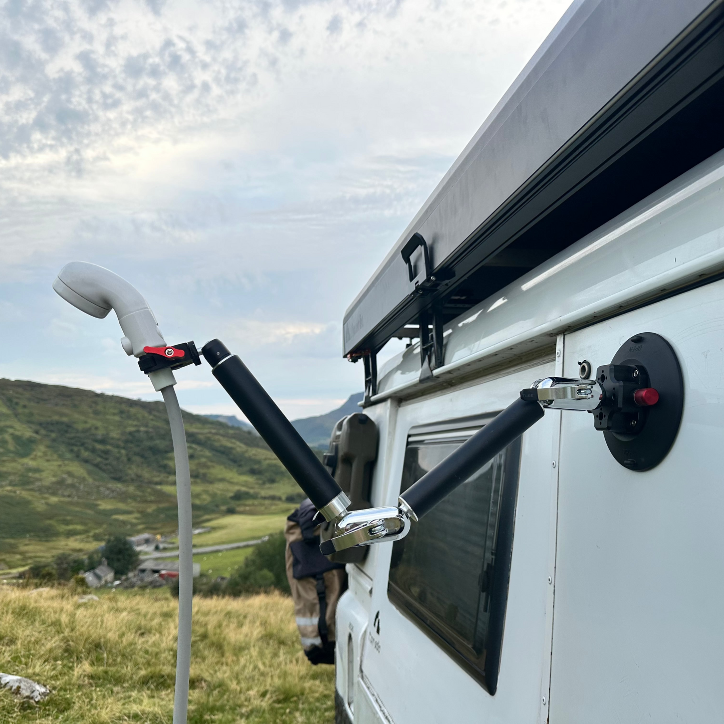 White van with Nomadia FlexMount Suction Arm used to hold water pump outdoor setting, perfect for takeing shower with ThermoFlow - outdoor shower system - camping and survival - portable shower for camping