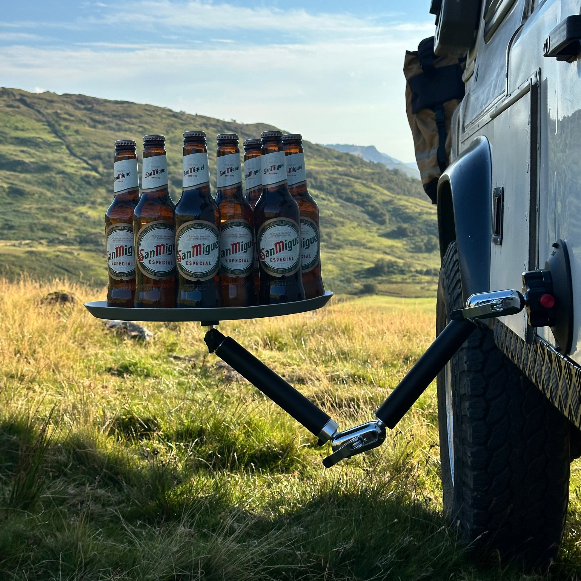 multiple beer bottles on a hitch rack Nomadia FlexMount Suction Arm with a scenic background - strong camping arm - outdoor gear