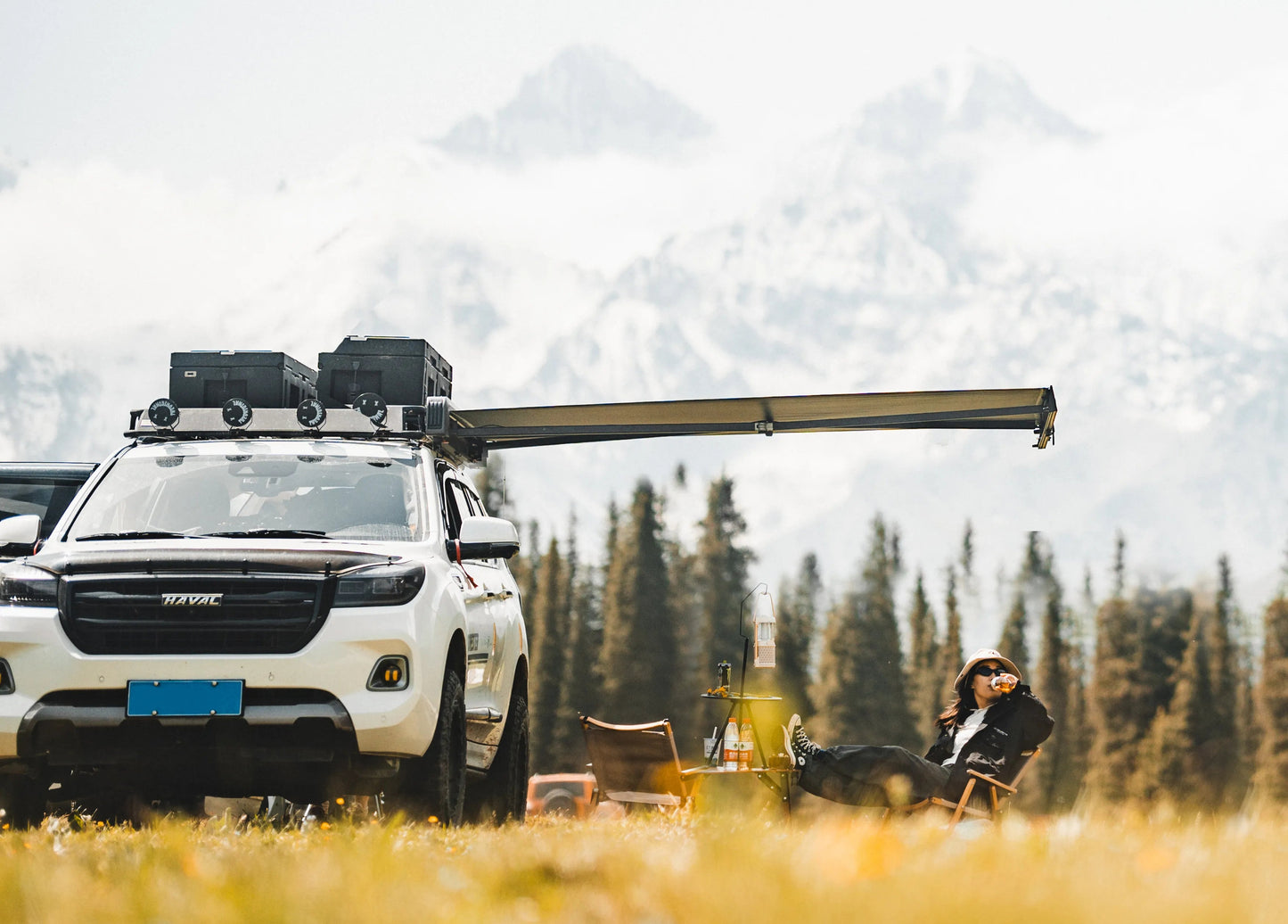 White SUV with Nomadia Glide World's fastest opening awning in a forest with mountains - aluminium awning - outdoor tent - quick setup tent - easy setup - all weather ready