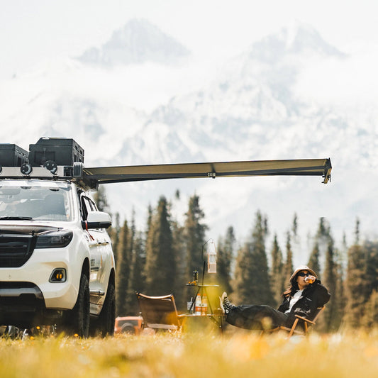White SUV with Nomadia Glide World's fastest opening awning in a forest with mountains - aluminium awning - outdoor tent - quick setup tent - easy setup - all weather ready