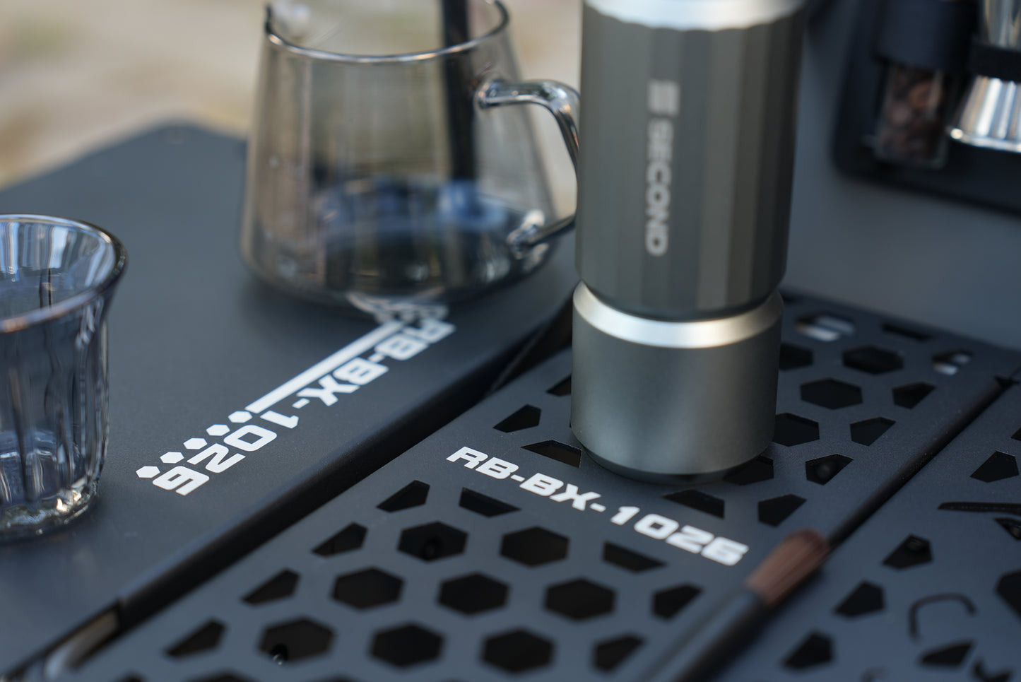close up of the board on Nomadia ModoBox 2in1 camping table and storage box with a coffee can - camping gear - glamping - uk camping