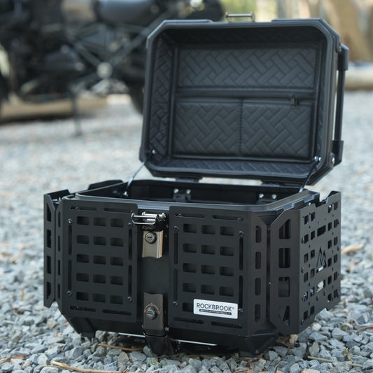 Black Nomadia ModoBox ArmorFold 45 Motorcycle Trunk & Camping Table storage box on a gravel surface - overlanding in uk - uk camping
