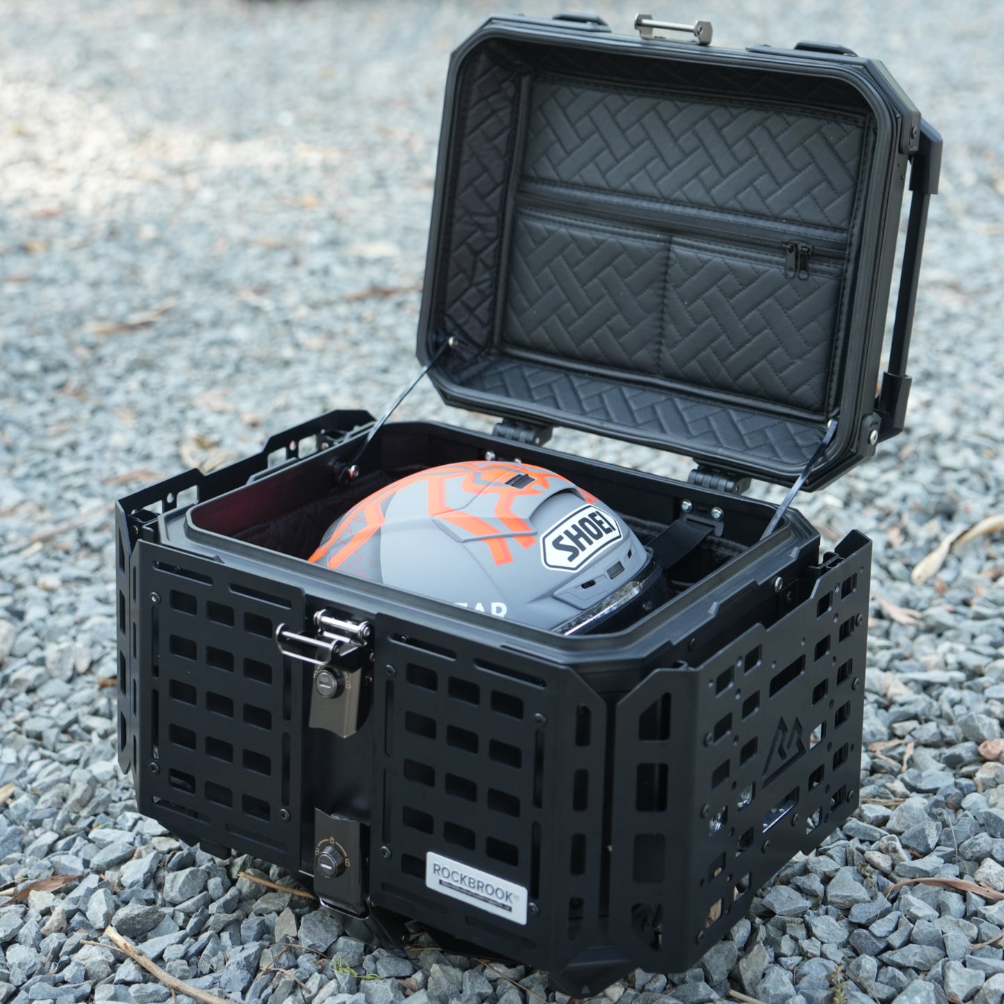 Black hard-shell protective case Nomadia ModoBox ArmorFold 45 Motorcycle Trunk Camping Table with a helmet inside - large storage crate for overlanding uk