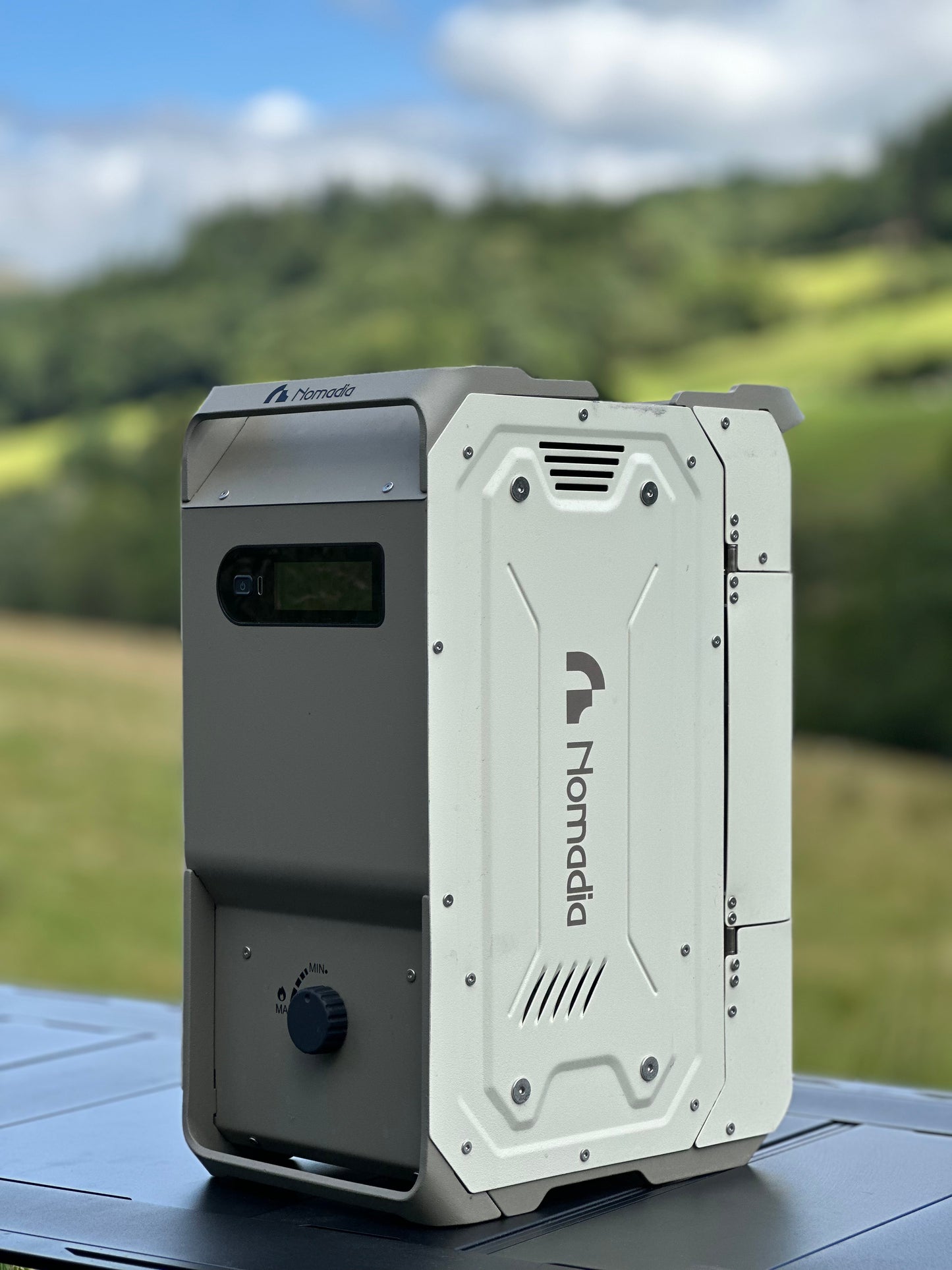 Nomadia Thermoflow portable heated shower system on a platform in natural background - wildcamping - shower solution - camping gear - world's most compact shower system