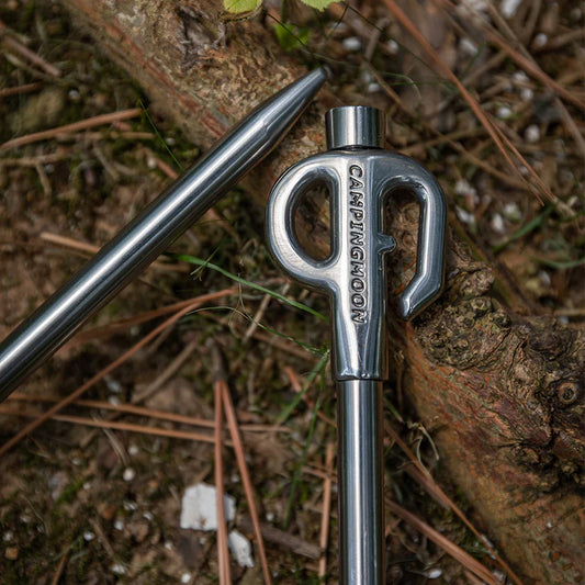 close up of Nomadia Accessory Camp Peg for Pet against a wooden background - camping gear 