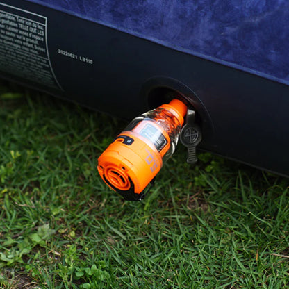 Nomadia Accessory High Speed 2-in-1 Rechargeable Air Pump pumping air mattress on grassy land - camping essential - uk camping