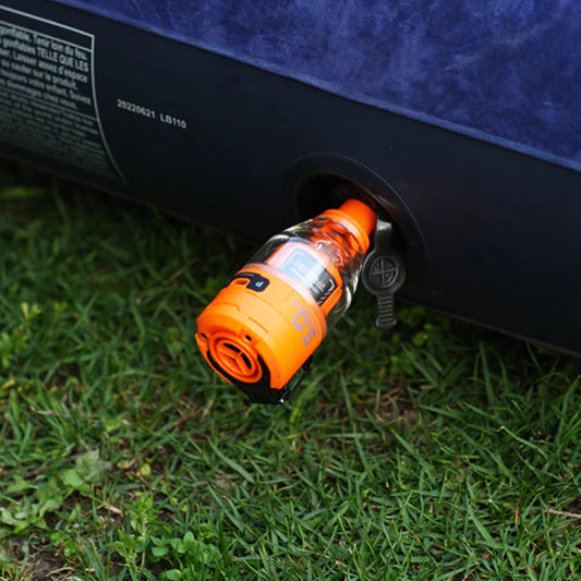 Nomadia Accessory High Speed 2-in-1 Rechargeable Air Pump pumping air mattress on grassy land - camping essential - uk camping