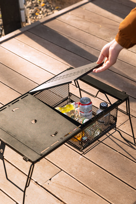 metal mesh basket in a modular table with drinks inside on wooden floor outdoor - storage use - camping gear - glamping - uk camping