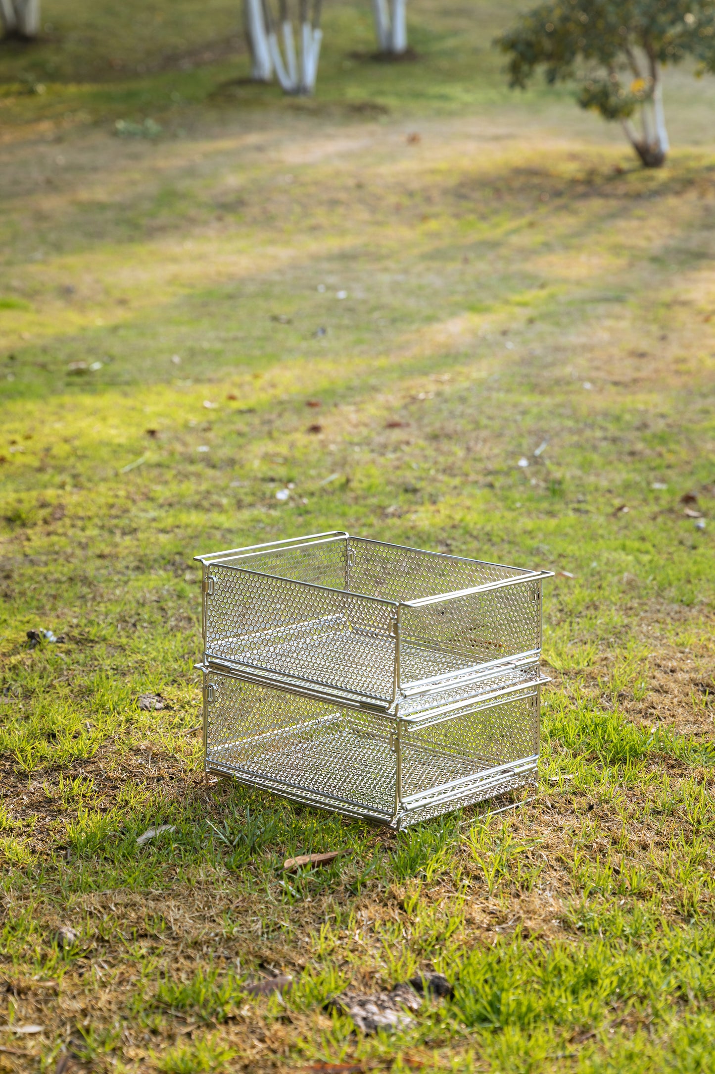 two metal mesh basket stacked together on grassland - wild camping - uk camping - strong - stable - camping gear