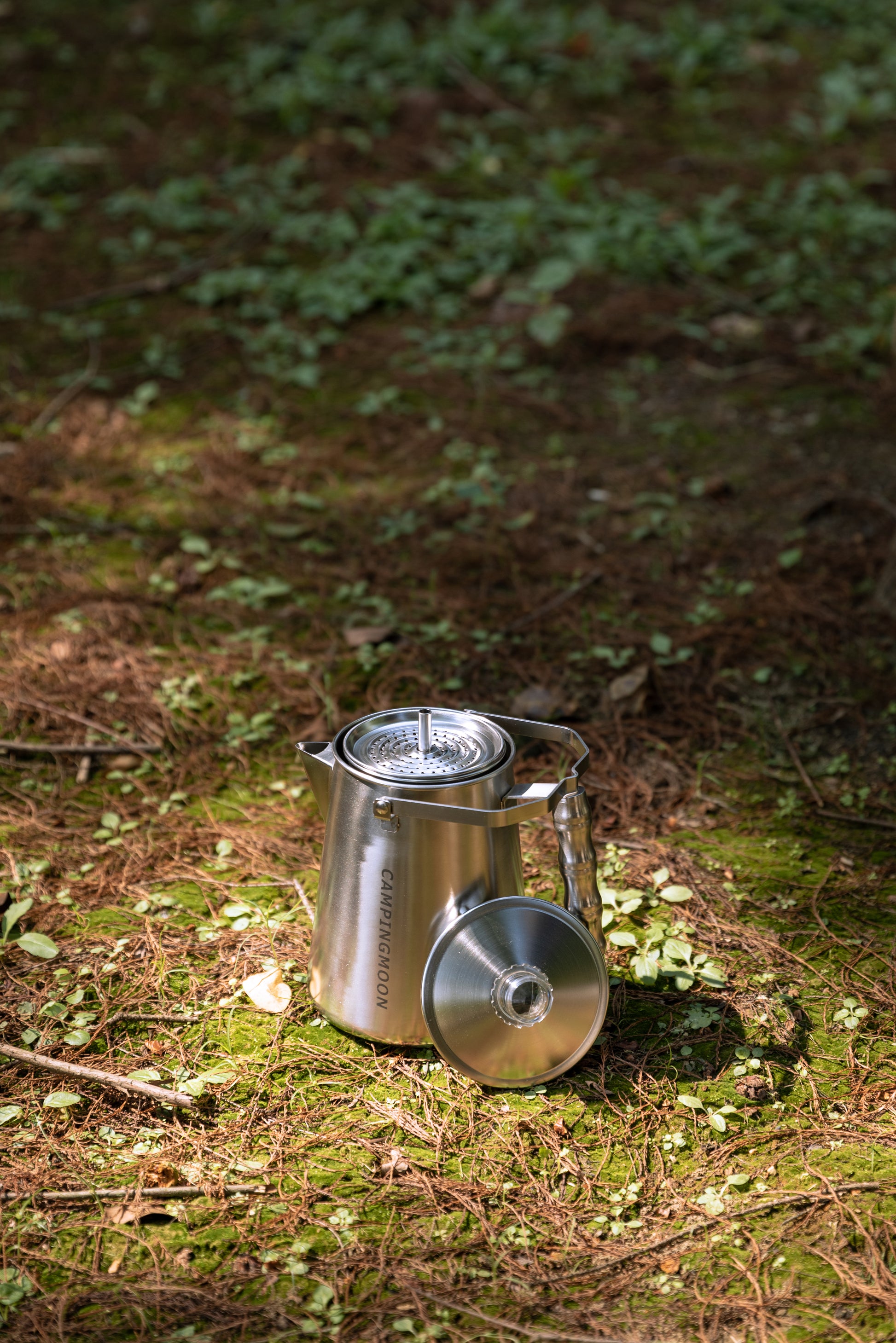Nomadia CampStation Stainless Steel Coffee Pot on a forest floor - glamping - camping coffee pot - outdoor coffee set - glamping