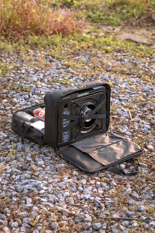 Black portable Nomadia CampStation Storage Bag on a gravel surface - uk camping - large storage compact camper bag