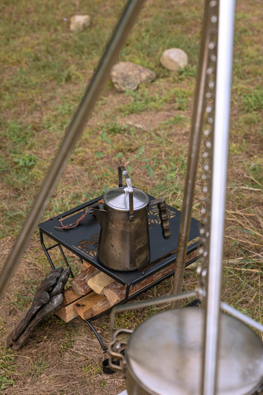Nomadia Flamo Crafted Camping Kettle on a small camping table - camping essential - atmospheric 