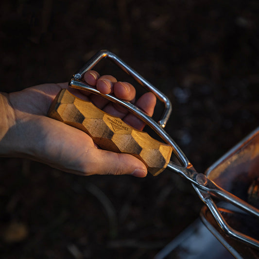 close up of the wood handle of nomadia flamo Precision Grip Fire Tongs - camping gear - camping essential - heavy duty tongs