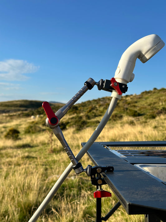 Nomadia FlexArm Dual Clamp used to hold shower head from thermoflow and table for easy showing outdoor - multi-use camping gear 