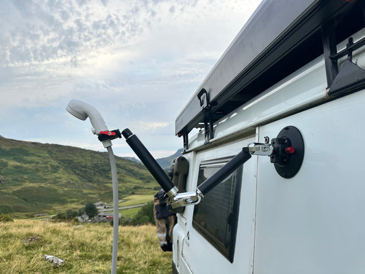 White van with Nomadia FlexMount Suction Arm used to hold water pump outdoor setting, perfect for takeing shower with ThermoFlow - outdoor shower system - camping and survival