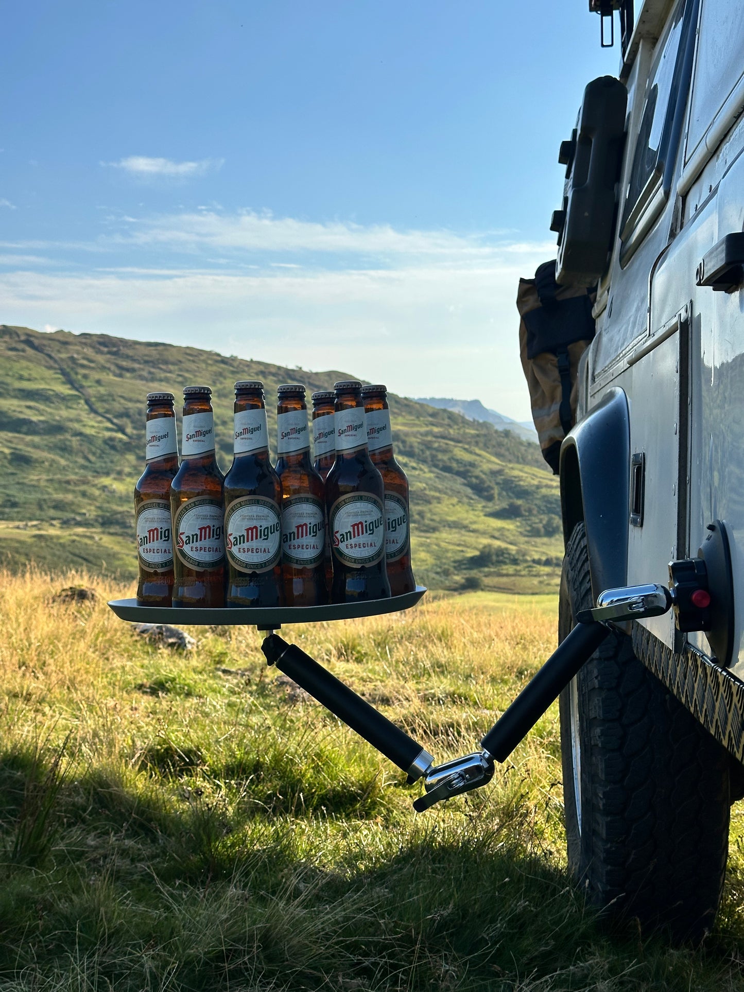 multiple beer bottles on a hitch rack Nomadia FlexMount Suction Arm with a scenic background - strong camping arm - outdoor gear 