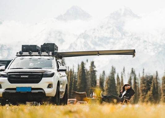 White SUV with Nomadia Glide World's fastest opening awning in a forest with mountains - aluminium awning - outdoor tent - quick setup tent - easy setup - all weather ready