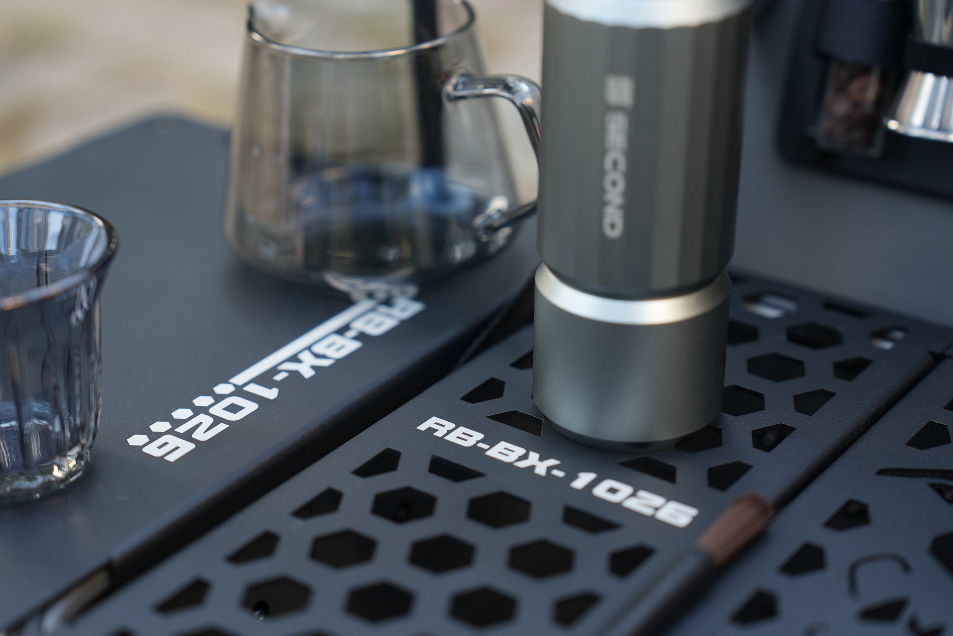 close up of the board on Nomadia ModoBox 2in1 camping table and storage box with a coffee can - camping gear - glamping - uk camping