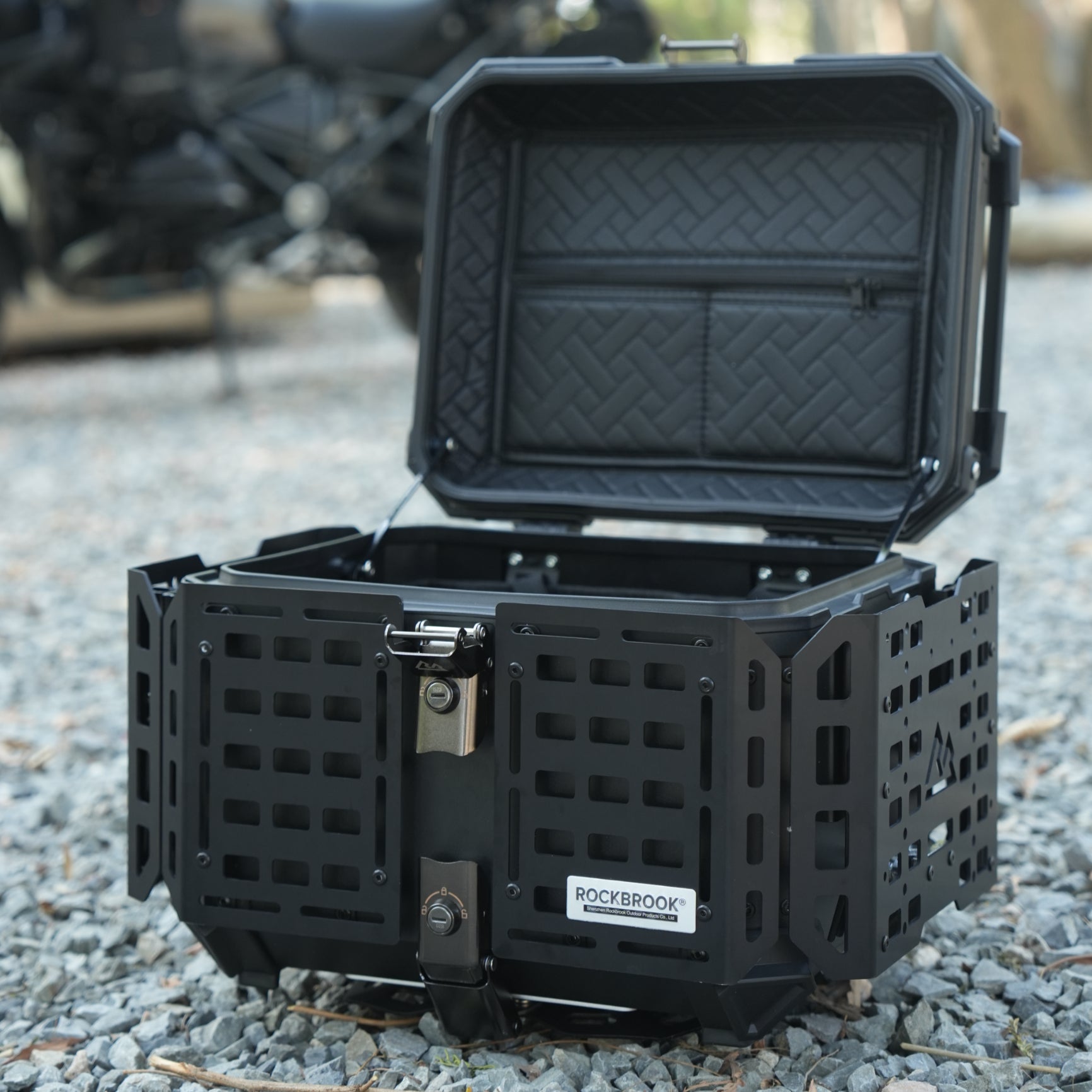 Black Nomadia ModoBox ArmorFold 45 Motorcycle Trunk & Camping Table storage box on a gravel surface - overlanding in uk - uk camping