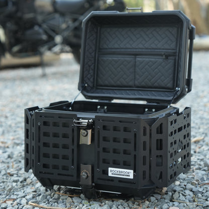 Black Nomadia ModoBox ArmorFold 45 Motorcycle Trunk & Camping Table storage box on a gravel surface - overlanding in uk - uk camping