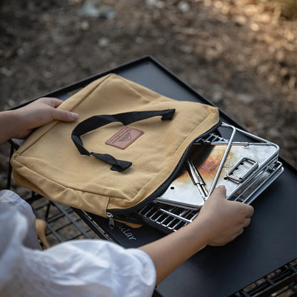 People opening the storage bag for Nomadia's Flamo Portable Folding BBQ Grill and Fire Pit mini - wildcamping - camping with a fire - uk camping