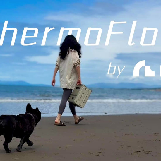 portable heated shower system ThermoFlow used by the sea to wash up muddy dogs